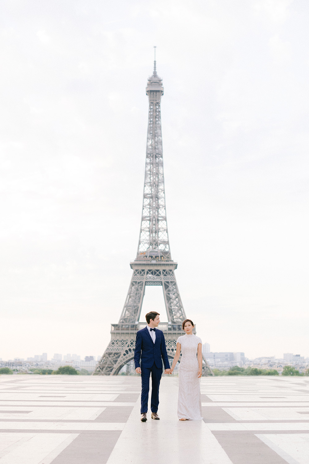 a couple in paris face to eiffel tower
